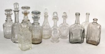 Eleven assorted cut glass decanters, some with stoppers,