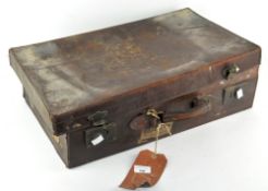 A vintage distressed leather suitcase,