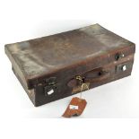 A vintage distressed leather suitcase,