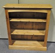A vintage pine bookcase with three shelves,