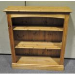 A vintage pine bookcase with three shelves,