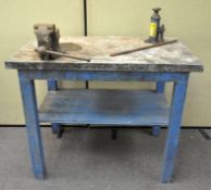 A vintage workbench with attached vice,