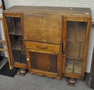 A vintage oak art deco mid century drinks cabinet with two glazed doors,