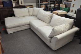 A large two-part corner sofa, with numerous cushions,