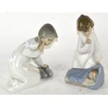 Two Lladro figures, an angel above a child, and another,