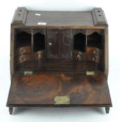 A mahogany fold-out collector's cabinet with three drawers to the base and fitted interior,