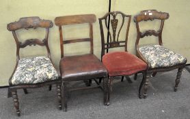 A group of four dining chairs, each with upholstered seats,