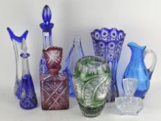 A collection of assorted glassware, including blue glass, a decanter and a claret jug,