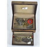 A vintage jewellery box containing a selection of costume jewellery,