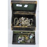 A vintage jewellery box containing costume jewellery,