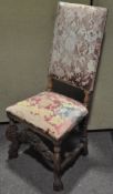 A 17th century style oak framed high back chair with upholstered seat and back,