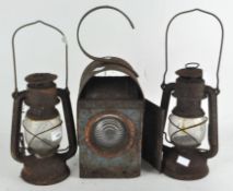 A railway lamp and two other lamps