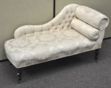 A short chaise longue, raised on turned supports,