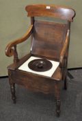 A Victorian mahogany commode chair with scrolled arm rests,