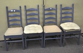 A set of four blue painted kitchen chairs, upholstered in a 100% cotton fabric,