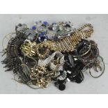 A tin of costume jewellery, to include bangles,