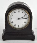 A small French oak cased mantel clock, the enamel dial with Roman numerals denoting hours,