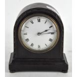 A small French oak cased mantel clock, the enamel dial with Roman numerals denoting hours,