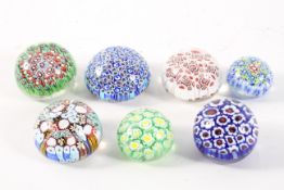 A collection of English and Scottish paperweights, with millefiori canes in a variety of styles,