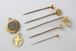 A collection of jewellery to include five tie pins, a mourning pendant and a cross pendant.