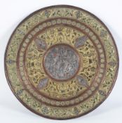 An Indian copper, brass and white metal charger, with applied decoration of various deities,