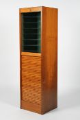 An oak tambour front filing cabinet, fitted with glass shelves,