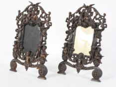 A pair of Renaissance style metal picture frames, cast with cherubs, swags and columns,