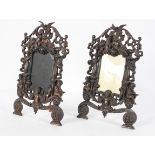 A pair of Renaissance style metal picture frames, cast with cherubs, swags and columns,