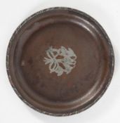 An Arts and Crafts hammered copper circular tray, by Hugh Wallis, inlaid with white metal snowdrops,