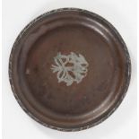 An Arts and Crafts hammered copper circular tray, by Hugh Wallis, inlaid with white metal snowdrops,