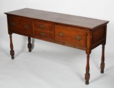 A Georgian style oak sideboard, the hinged top above a set of false drawers on baluster turned legs,