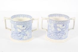 A pair of pearlware blue and white loving cups, printed with a rose flower design,
