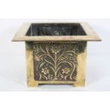 A brass Arts and Crafts style jardiniere, of square section,