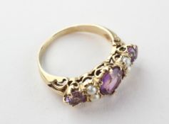 A yellow metal half hoop ring set with amethyst and seed pearls. No hallmark - stamped 9ct.