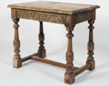 A Carolean style oak side table, with foliate carved border, turned legs and H stretcher,