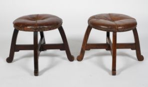 A pair of walnut and leather Arts and Crafts upholstered stools,