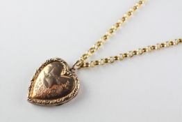 An ornate rose metal heart locket pendant suspended from a yellow gold 18 inch belcher chain.