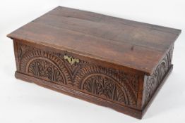 An oak Bible box, late 17th/early 18th century, carved with arching and foliate decoration,