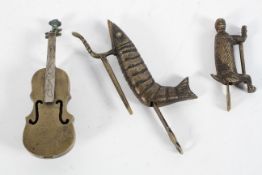 Three novelty brass locks, in the form of a cello, crayfish and monkey,