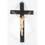 A medieval style bone Corpus Christi suspended from an ebonised cross, 16th century,