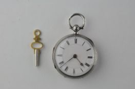 An open face pocket watch. Circular white dial with Roman numerals.