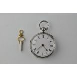 An open face pocket watch. Circular white dial with Roman numerals.