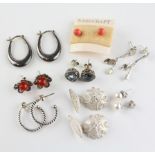 A collection of seven pairs of earrings together with a pair of filigree floral cufflinks