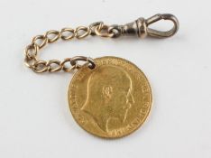 A half sovereign coin dated 1905. Drilled and fitted with a length of chain and swivel clasp.