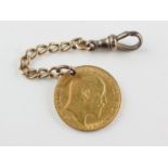 A half sovereign coin dated 1905. Drilled and fitted with a length of chain and swivel clasp.