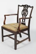 A mahogany George III 'Chippendale' armchair, with upholstered drop-in seat on square reeded legs,