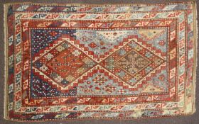 A Kazak rug, central Caucasus, the abrushed indigo ground with two stepped diamond medallions,