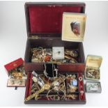 A jewellery case containing a large selection of assorted costume jewellery and wristwatches
