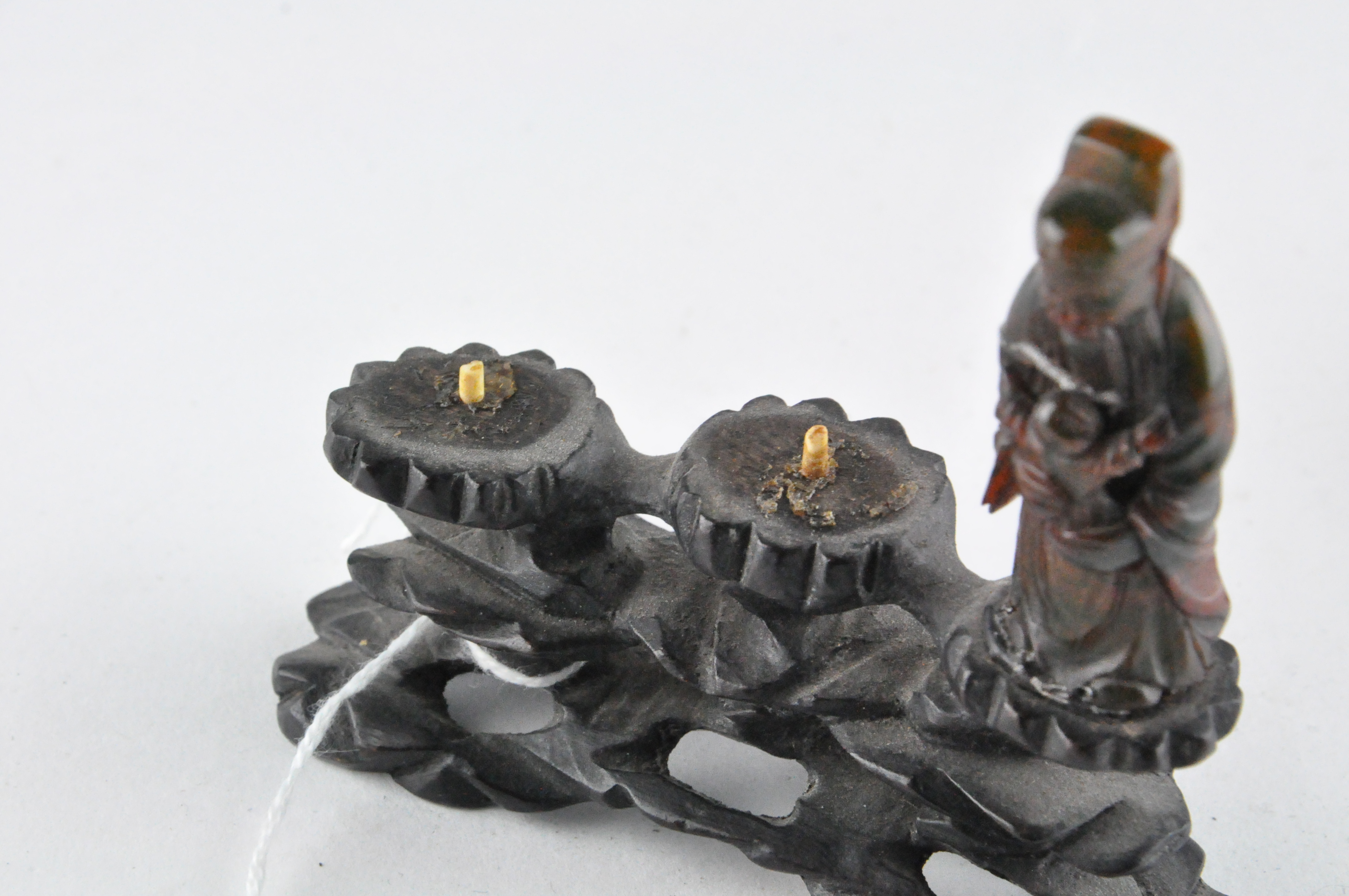 A group of three Chinese amber style figures of Immortals, standing on a carved wood base, - Image 9 of 9
