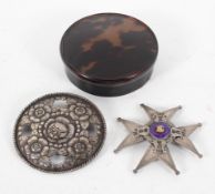 A Norwegian white metal star shaped brooch, with enamelled decoration to centre,